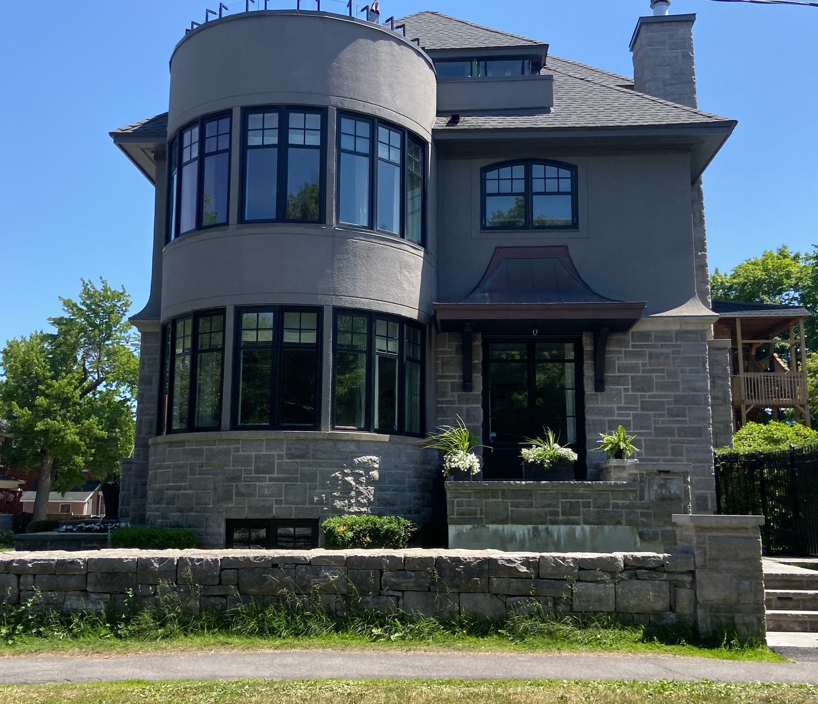 Stone heritage home with dark steel roof