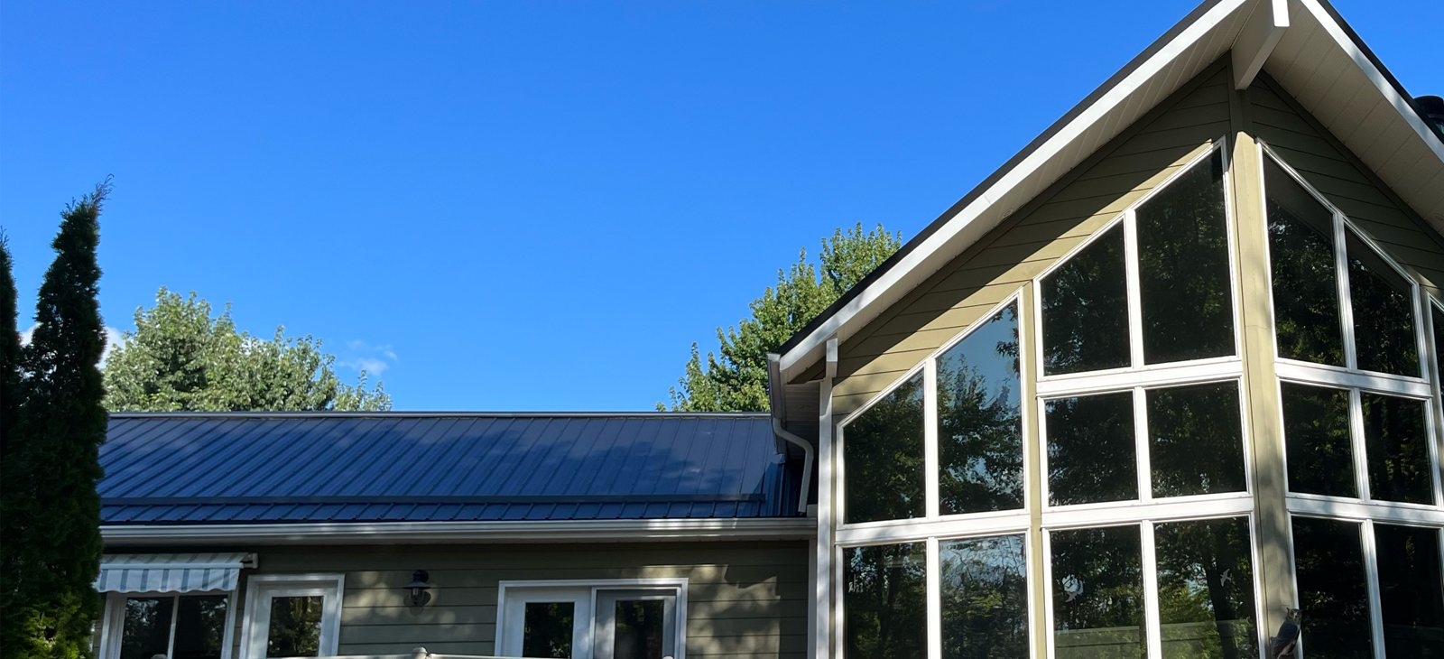 Steel roof over a glass-walled great room addition