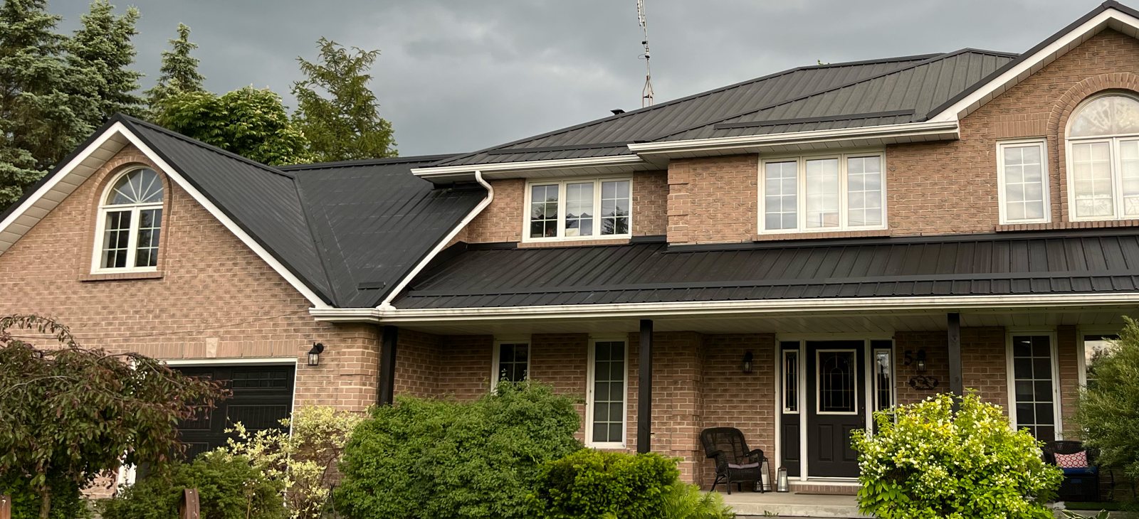 Brick two-storey with dark metal roof