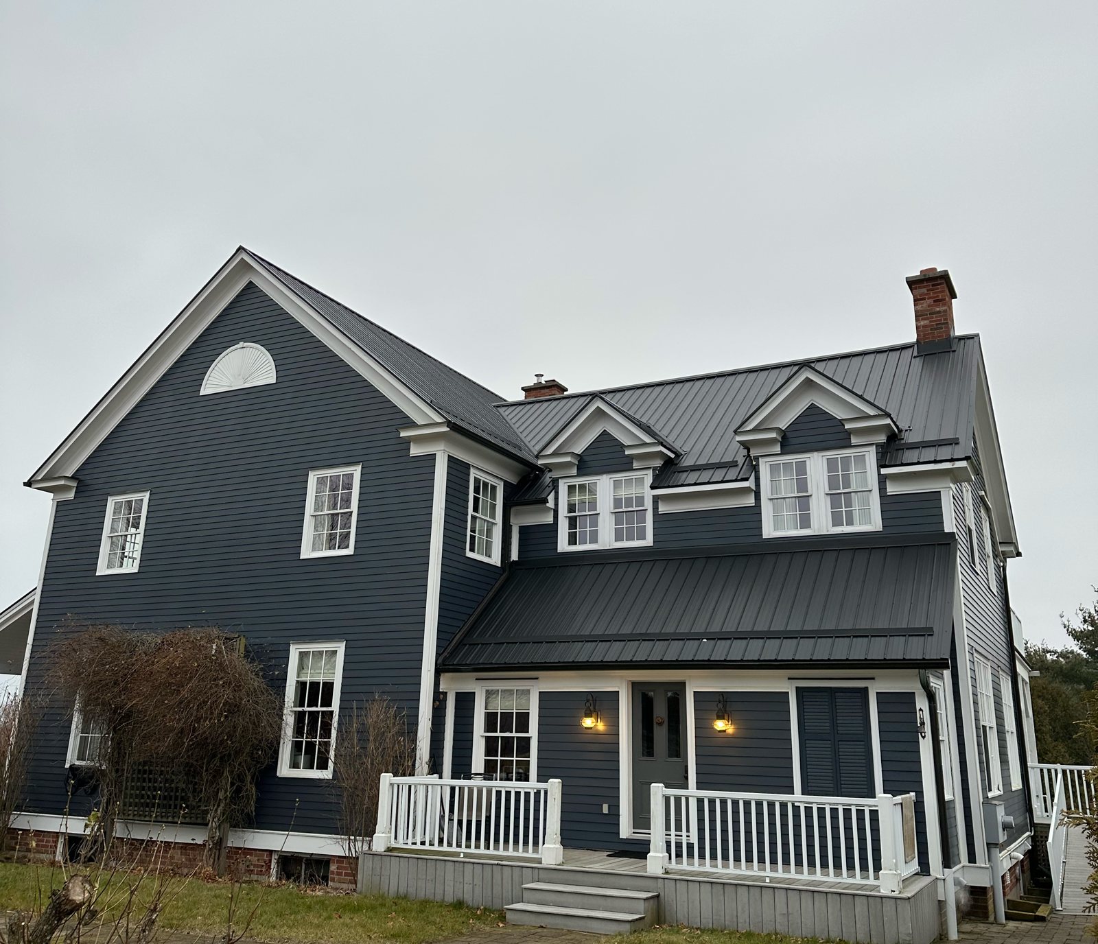 Navy home with steel roof and covered porch